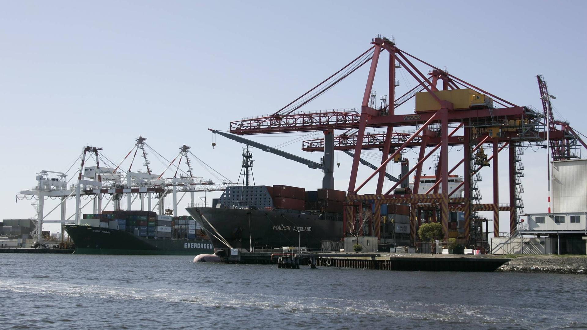 Im Containerhafen von Melbourne in Australien sind zahlreiche Kräne und mehrere Schiffe zu sehen. Im Containerhafen von Melbourne in Australien sind zahlreiche Kräne und mehrere Schiffe zu sehen.