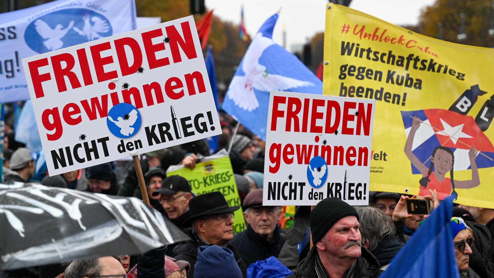 Teilnehmer einer Friedensdemonstration halten unter anderem Plakate mit der Aufschrift "Frieden gewinnen, nicht den Krieg". Teilnehmer einer Friedensdemonstration halten unter anderem Plakate mit der Aufschrift "Frieden gewinnen, nicht den Krieg".