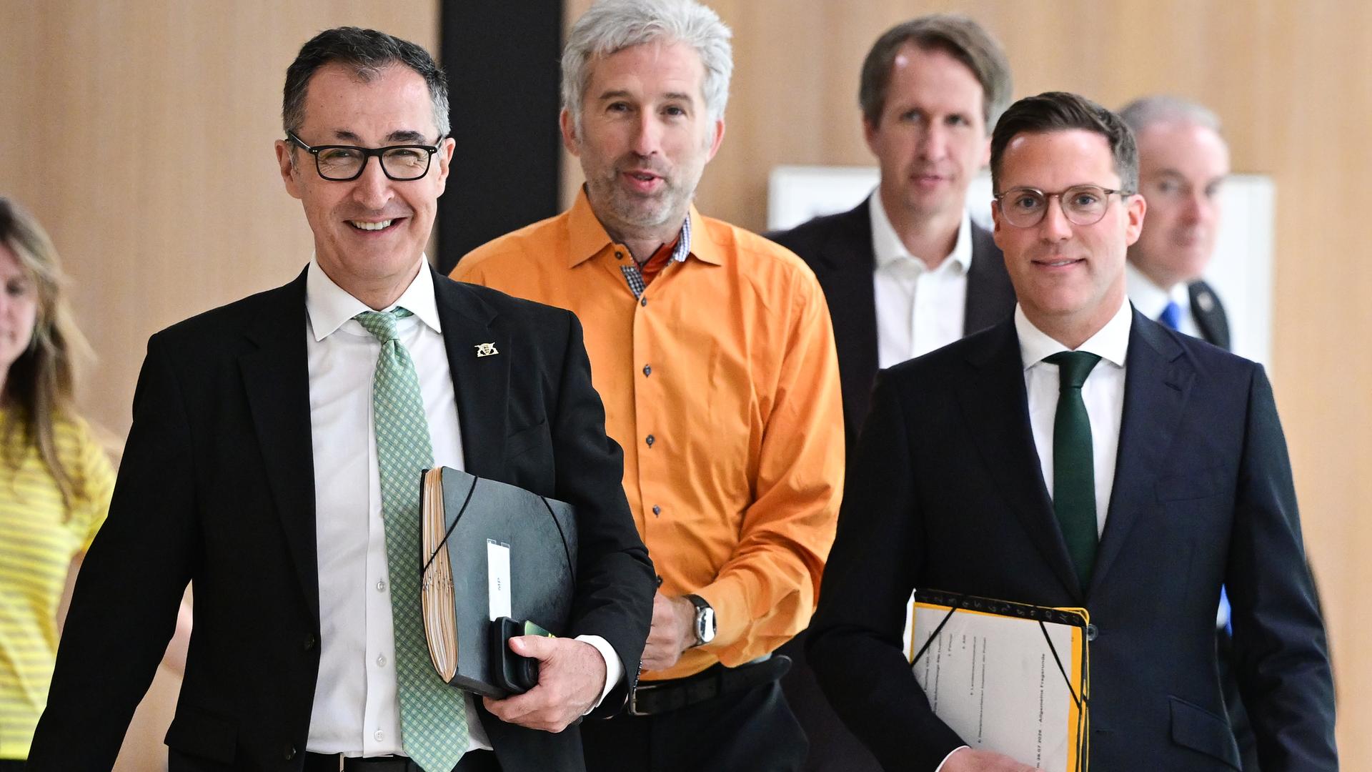 Stuttgart: Cem Özdemir (Bündnis 90/Die Grünen, l-r), Ministerpräsident in Baden-Württemberg, Boris Palmer (parteilos), Oberbürgermeister der Stadt Tübingen und Manuel Hagel (CDU) Innenminister in Baden-Württemberg, gehen gemeinsam zu einer Pressekonferenz.