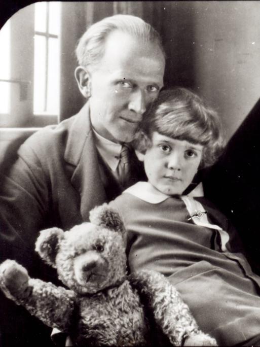 Schwarzweißfoto mit dem Autor A. A. Milne und sein Sohn Christopher Robin sowie die Plüschpuppe Winnie the Pooh. Schwarzweißfoto mit dem Autor A. A. Milne und sein Sohn Christopher Robin sowie die Plüschpuppe Winnie the Pooh.