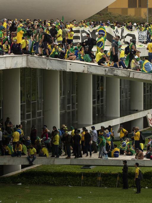 BRASILIA, BRASILIEN – 8. JANUAR: Anhänger des ehemaligen Präsidenten Jair Bolsonaro stoßen mit Sicherheitskräften zusammen, als sie den Nationalkongress in Brasilia, Brasilien, am 8. Januar 2023 überfallen. Gruppen, die Parolen riefen, die ein Eingreifen der Armee forderten, durchbrachen die Polizeibarriere und betraten das Kongressgebäude , laut lokalen Medien. Die Polizei griff mit Tränengas ein, um Pro-Bolsonaro-Demonstranten auseinanderzutreiben. Joedson Alves / Agentur Anadolu BRASILIA, BRASILIEN – 8. JANUAR: Anhänger des ehemaligen Präsidenten Jair Bolsonaro stoßen mit Sicherheitskräften zusammen, als sie den Nationalkongress in Brasilia, Brasilien, am 8. Januar 2023 überfallen. Gruppen, die Parolen riefen, die ein Eingreifen der Armee forderten, durchbrachen die Polizeibarriere und betraten das Kongressgebäude , laut lokalen Medien. Die Polizei griff mit Tränengas ein, um Pro-Bolsonaro-Demonstranten auseinanderzutreiben. Joedson Alves / Agentur Anadolu