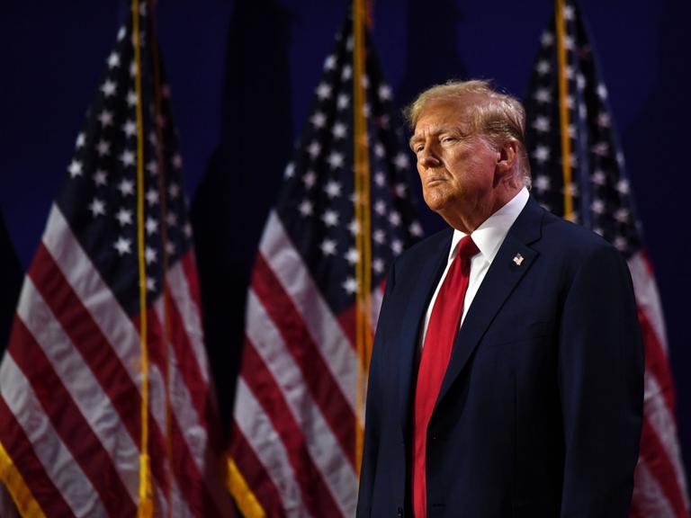 Der ehemalige Präsident Donald Trump steht vor US-Flaggen auf der Road to Majority Conference in Washington DC am 22. Juni 2024.