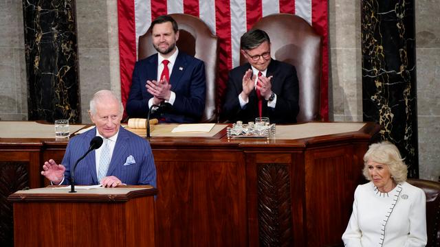 König Charles steht am Redepult im US-Kongress und hält eine Rede. Hinter ihm applaudieren Speaker Mike Johnson und Vize-Präsident Vance. Königin Camilla sitzt daneben.