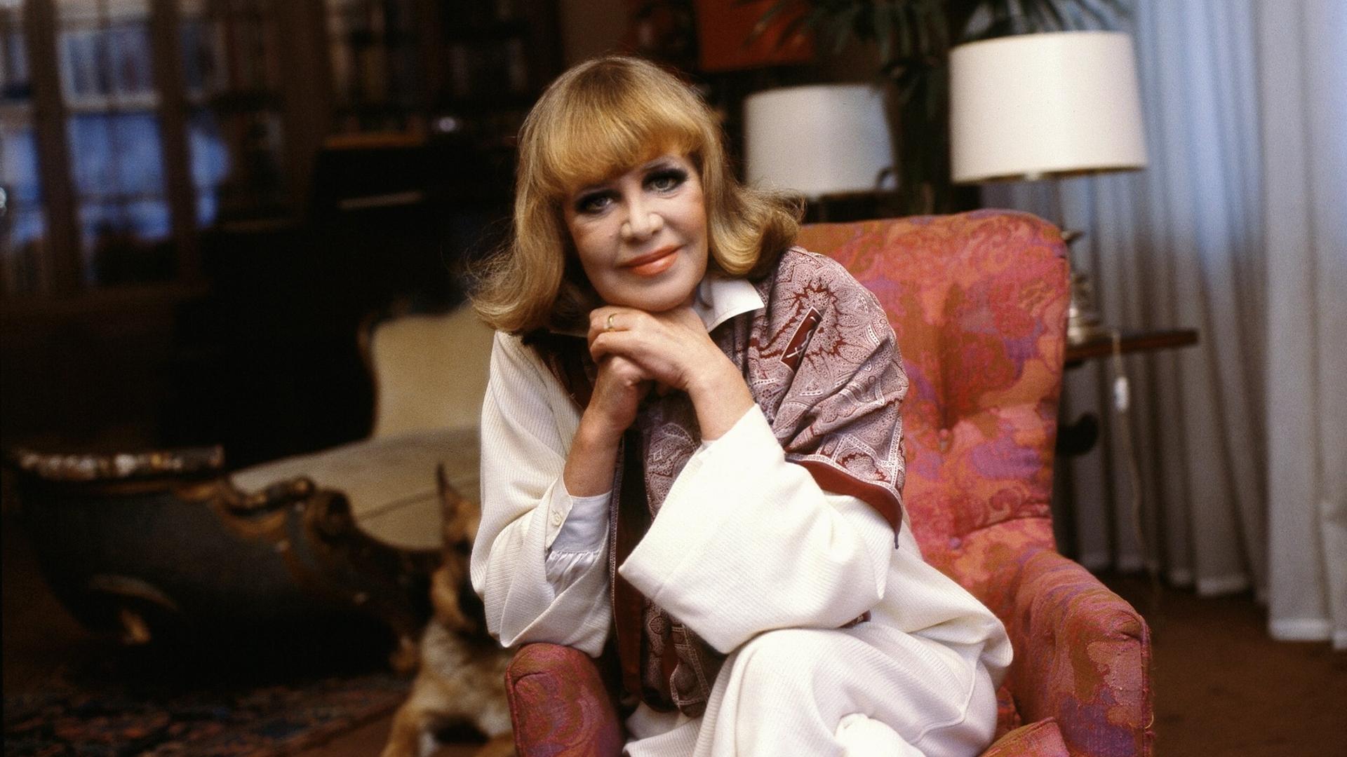 Porträtfoto zeigt Hildegard Knef in einem Sessel sitzend in ihrer Berliner Wohnung, 1980