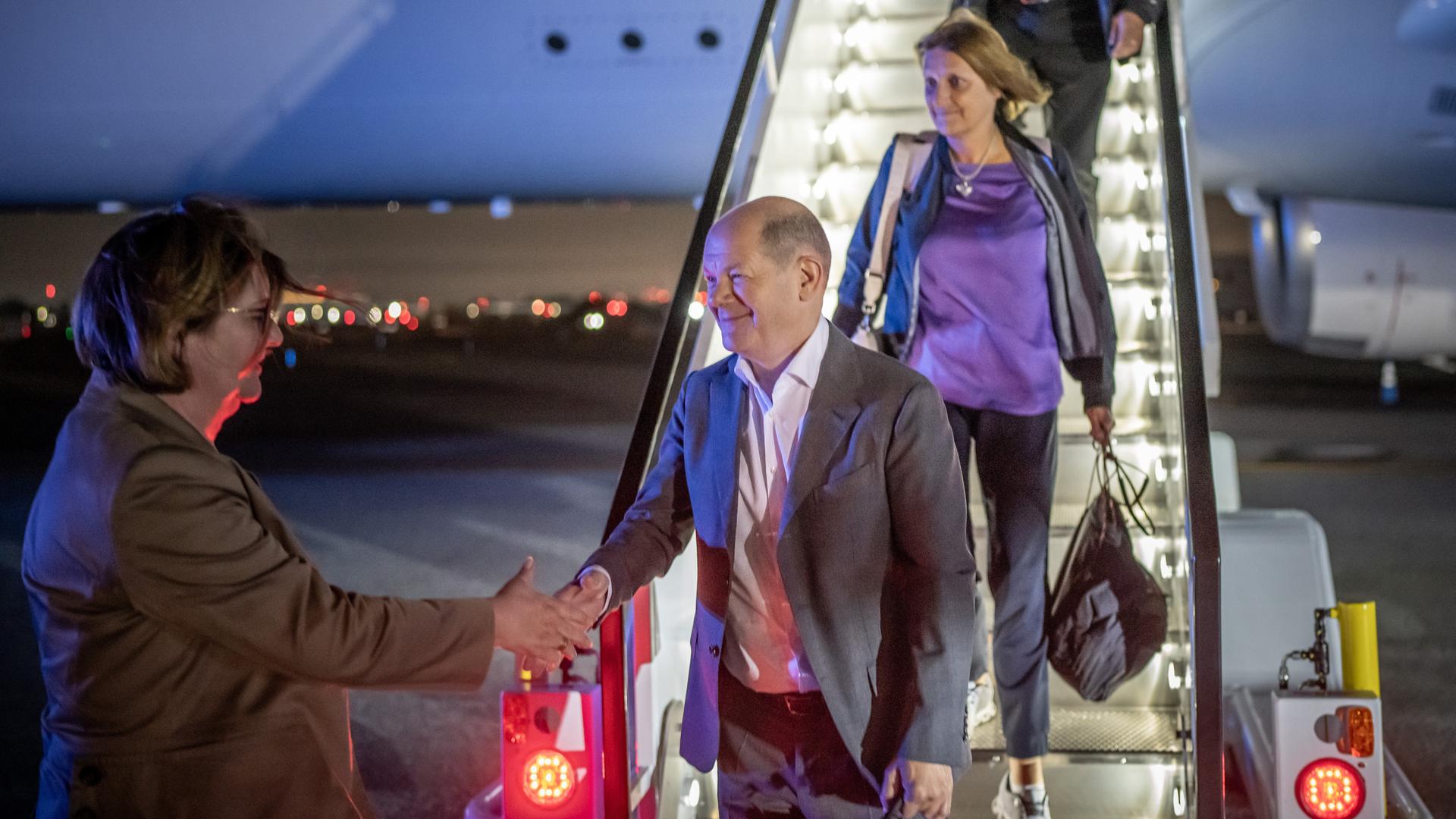 Bundeskanzler Olaf Scholz (SPD), kommt zusammen mit seiner Frau Britta Ernst, am Flughafen in New York an und wird von Botschafterin Antje Leendertse (l), Ständige Vertreterin Deutschlands bei den Vereinten Nationen, begrüßt. 