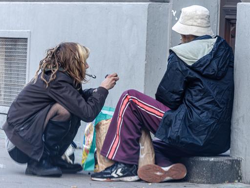 Zwei Abhängige konsumieren Drogen in einem Seiteneingang des Hamburger Schauspielhauses.
