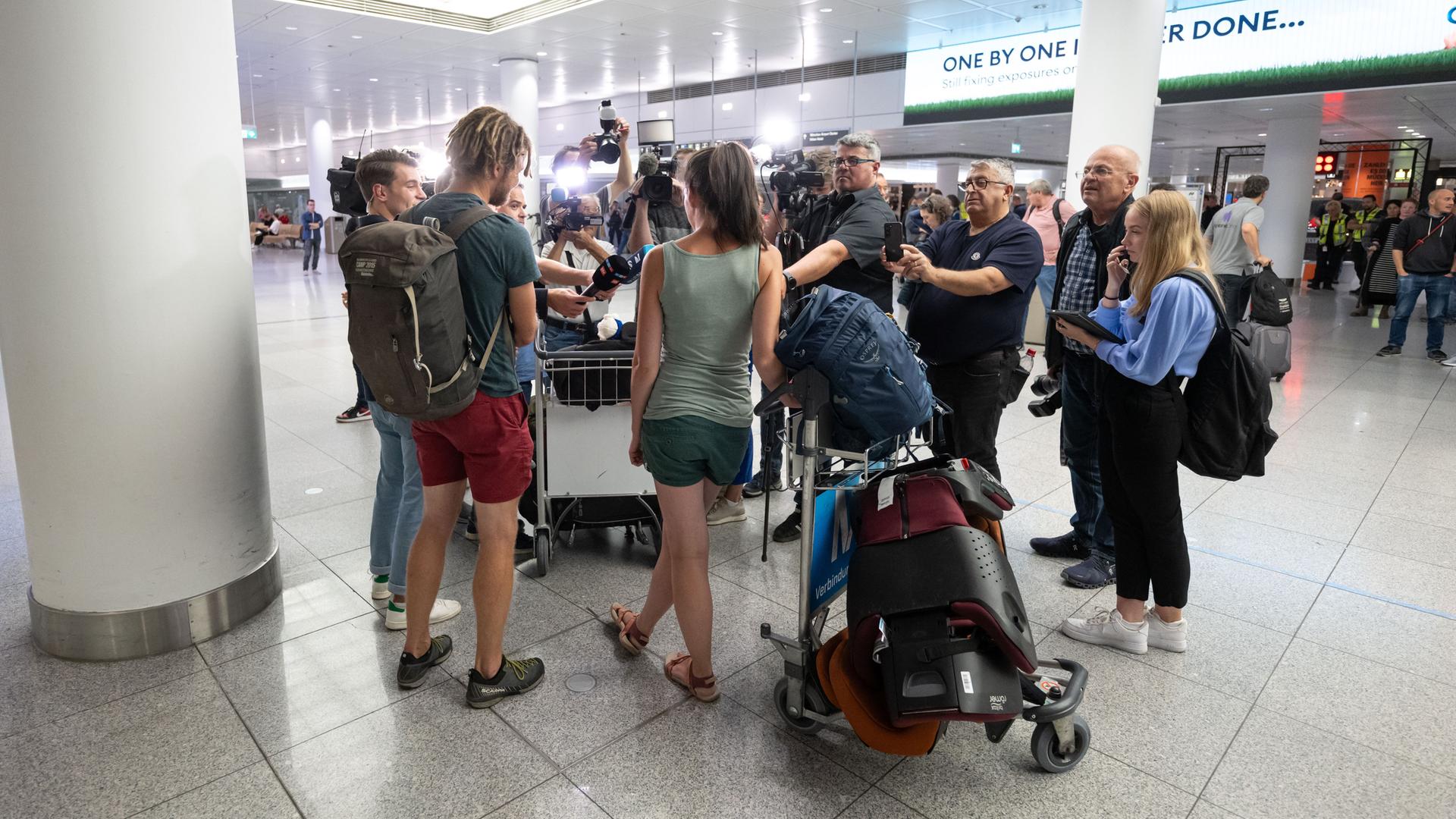 Die Touristen Franziska (M) und Alex Hanicke (2.v.r) sprechen mit den Medien, nachdem sie mit einem von der Bundesregierung organisierten Sonderflug der Lufthansa aus Tel Aviv, Israel, am Flughafen München ankamen. Die Touristen Franziska (M) und Alex Hanicke (2.v.r) sprechen mit den Medien, nachdem sie mit einem von der Bundesregierung organisierten Sonderflug der Lufthansa aus Tel Aviv, Israel, am Flughafen München ankamen.