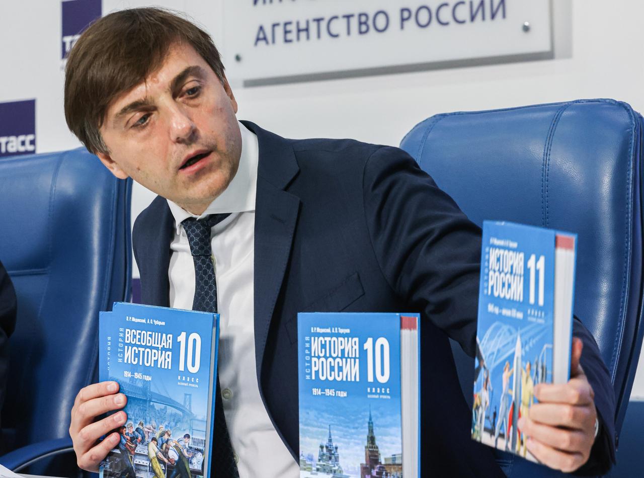 Das Bild zeigt den russischen Bildungsminister Krawtsow, der ein neues Geschichtsbuch für Schüler vorstellt, das den russischen Angriffskrieg auf die Ukraine glorifiziert.