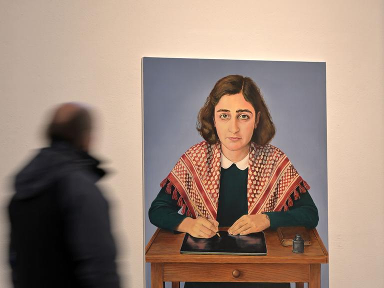 auf einem Genälde ist das im Holocaust ermordete jüdische Mädchen Anne Frank mit einer Kufiya, einem Palästinensertuch, zu sehen.