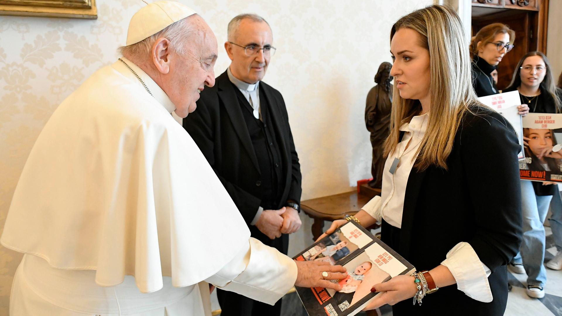 Vatikan, Vatikanstadt: Papst Franziskus berührt das Foto eines Kindes, während er sich mit Angehörigen von israelischen Geiseln trifft, die von der palästinensischen Terrororganisation Hamas festgehalten werden. Vatikan, Vatikanstadt: Papst Franziskus berührt das Foto eines Kindes, während er sich mit Angehörigen von israelischen Geiseln trifft, die von der palästinensischen Terrororganisation Hamas festgehalten werden.