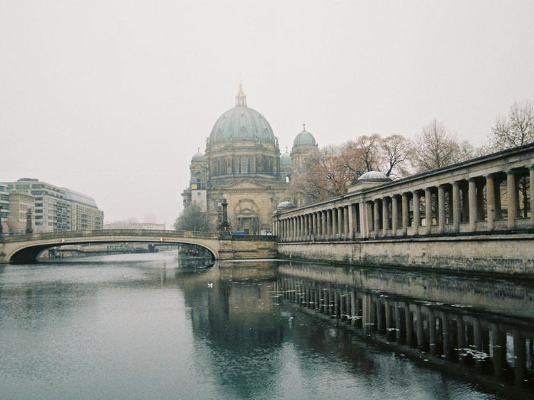 Blick über die Spree zum Dom, der von Nebel umgeben ist.