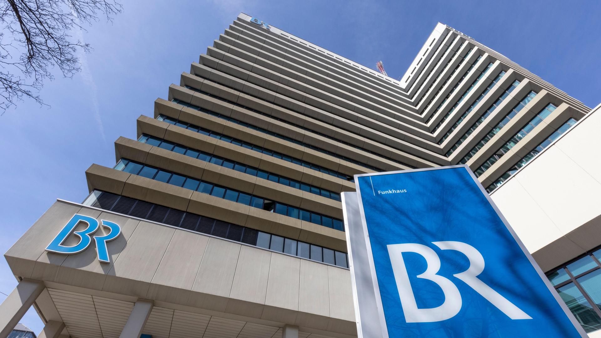 Vor dem Münchner Funkhaus des Bayerischen Rundfunk steht auf einem blauen Schild das Logo des Senders mit den Buchstaben "BR".