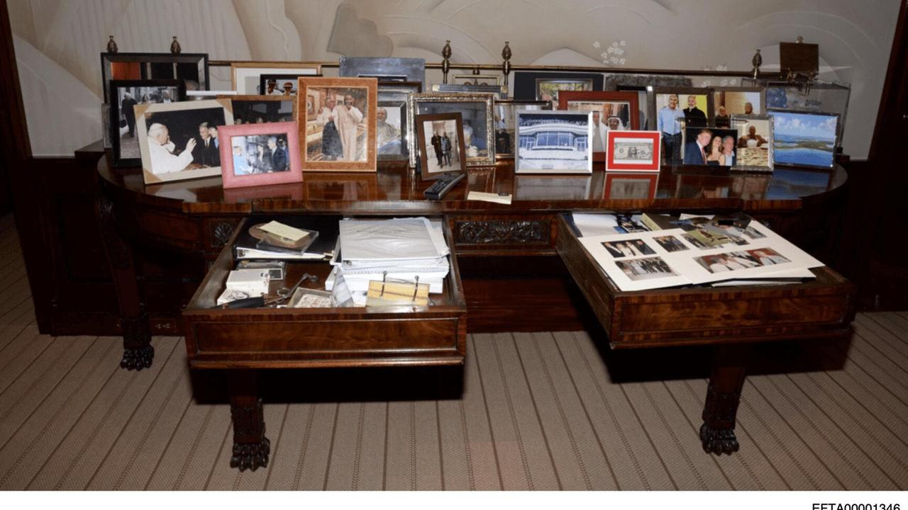Zu sehen ist der Schreibtisch des verurteilten Sexualstraftäters Epstein mit geöffneter Schublade. Auf dem Schreibtisch stehen viele Bilder, in der Schublade liegen Unterlagen und Fotos.