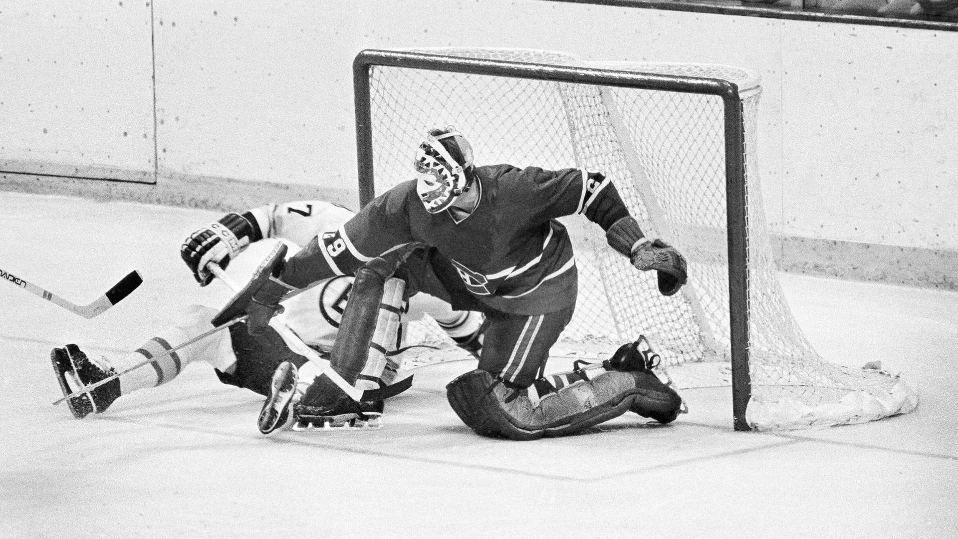 Der verstorbene kanadische Eishockey-Torhüter Ken Dryden kniet während eines Spiels im Jahr 1979 vor dem Tor, neben ihm ein anderer Spieler. 