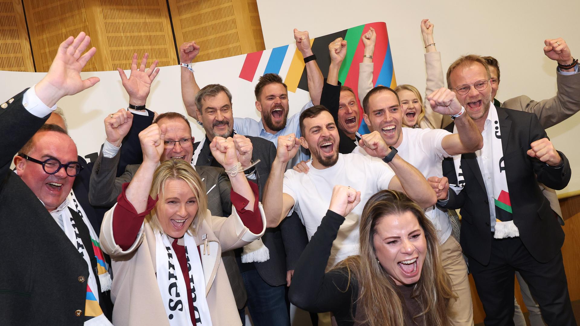 Eine Gruppe von Menschen jubelt. Eine Gruppe von Menschen jubelt.