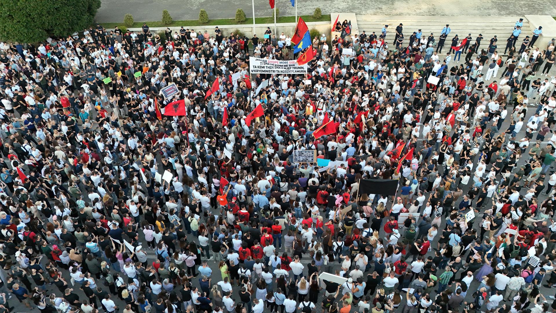 Tausende von Demonstranten, die Transparente und Plakate tragen, versammeln sich am Skanderbeg-Platz in Tirana, Albanien.