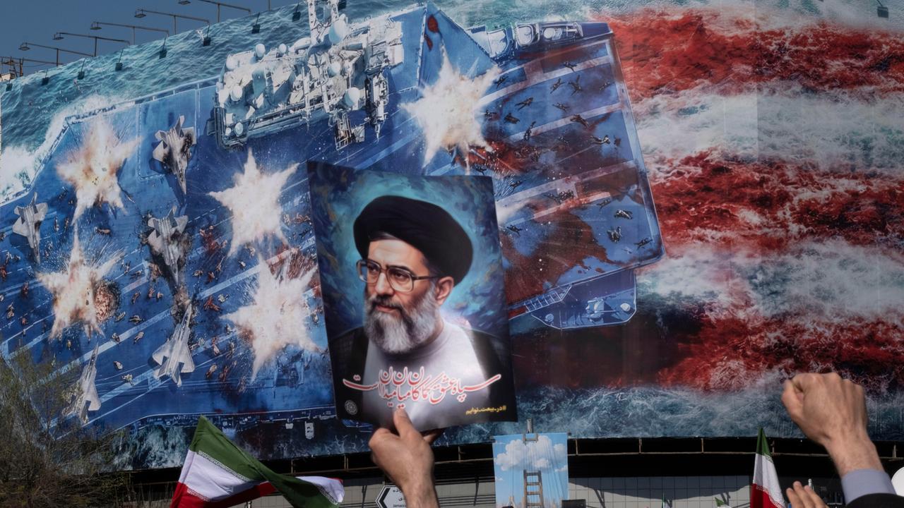An Iranian man holds up a portrait of Iran's Supreme Leader Ayatollah Ali Khamenei during a rally in Tehran, Iran, on March 1, 2026, following the confirmation of Ayatollah Khamenei's death by state TV