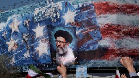 An Iranian man holds up a portrait of Iran's Supreme Leader Ayatollah Ali Khamenei during a rally in Tehran, Iran, on March 1, 2026, following the confirmation of Ayatollah Khamenei's death by state TV