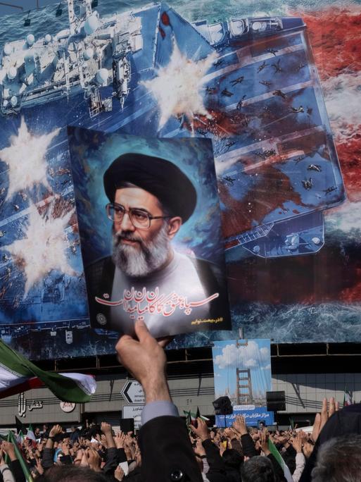 An Iranian man holds up a portrait of Iran's Supreme Leader Ayatollah Ali Khamenei during a rally in Tehran, Iran, on March 1, 2026, following the confirmation of Ayatollah Khamenei's death by state TV