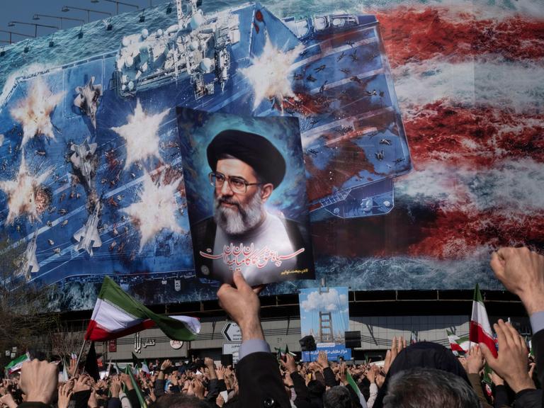 An Iranian man holds up a portrait of Iran's Supreme Leader Ayatollah Ali Khamenei during a rally in Tehran, Iran, on March 1, 2026, following the confirmation of Ayatollah Khamenei's death by state TV