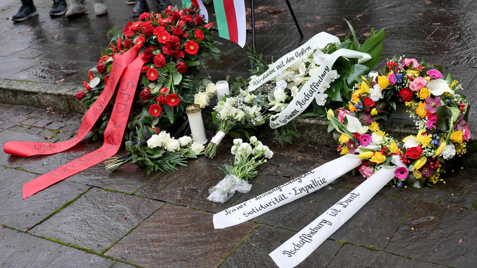 Kränze und Blumen liegen nach dem tödlichen Angriff in einem Park in Aschaffenburg.