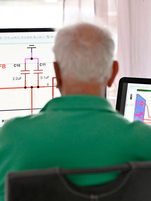 Ein Senior arbeitet in seiner Elektronik-Werkstatt im Home-Office.