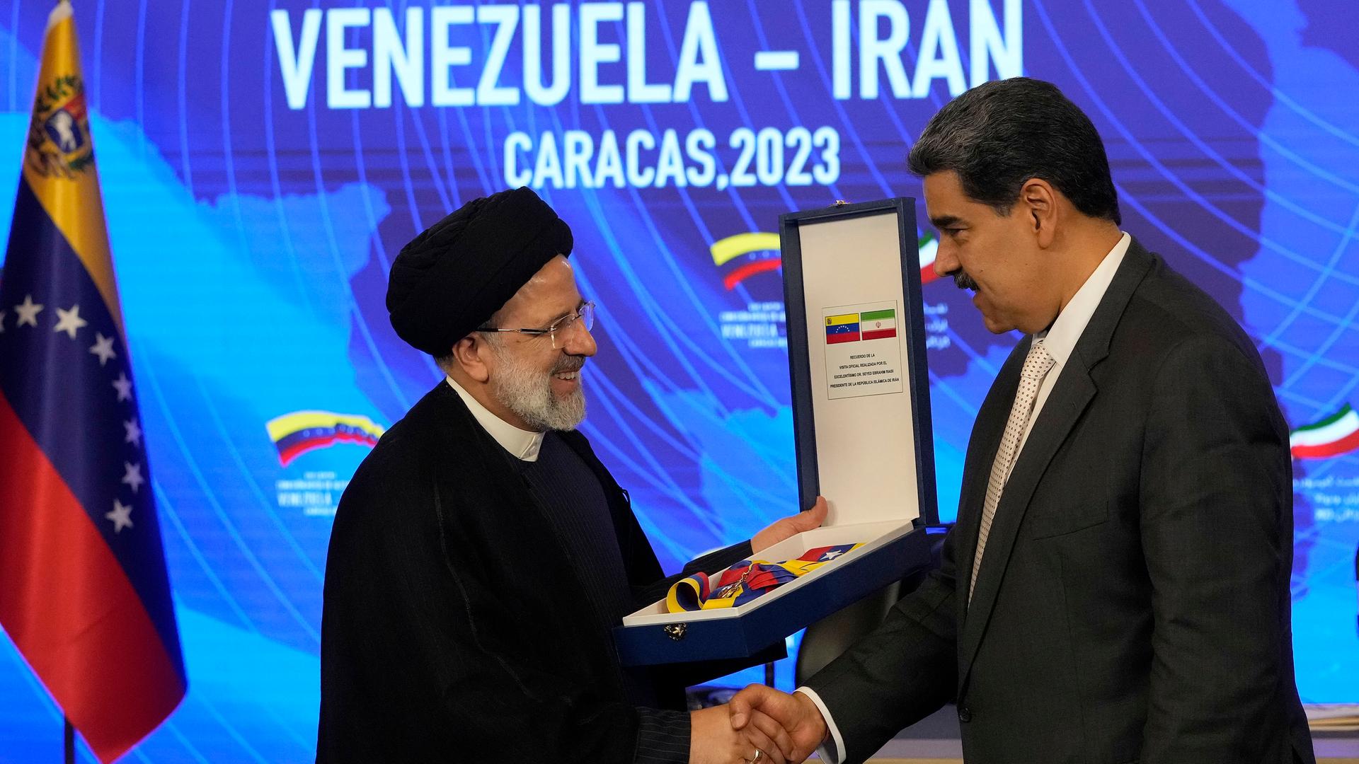 Ebrahim Raisi, Präsident von Iran, gibt Nicolas Maduro, Präsident von Venezuela, die Hand, als er den Orden "Libertador y Libertadora de Primera Clase" im Präsidentenpalast Miraflores entgegennimmt.