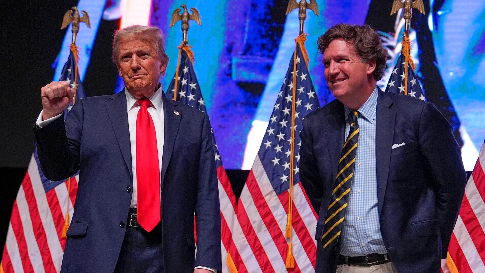 Präsident Donald Trump, damals noch Präsidentschaftskandidatin,  im Gespräch mit Tucker Carlson während einer "Tucker Carlson Live Tour"-Show in der Desert Diamond Arena am 31. Oktober 2024 in Glendale, Arizona.