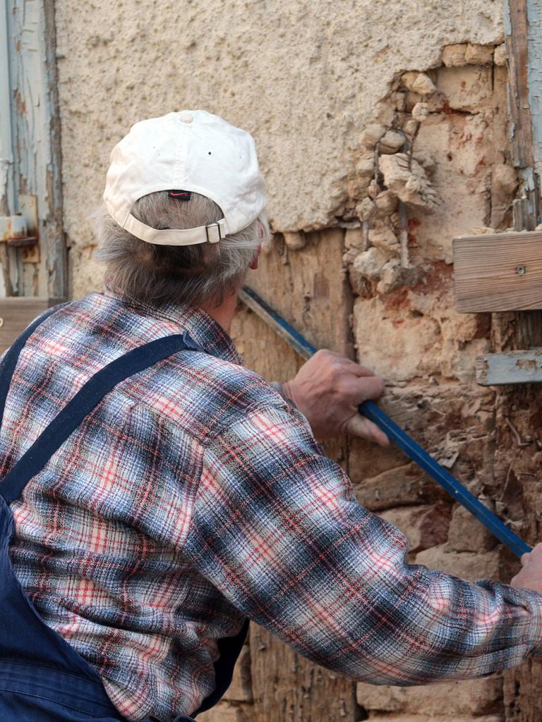 Handwerker bei Restaurierungsarbeiten an einem Fachwerkhaus 