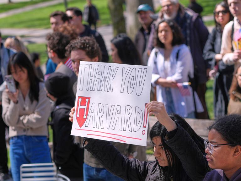 Harvard-Studierende bei einer Protestkundgebung. Eine Person hält ein Schild mit der Aufschrift "Thank you Harvard!"