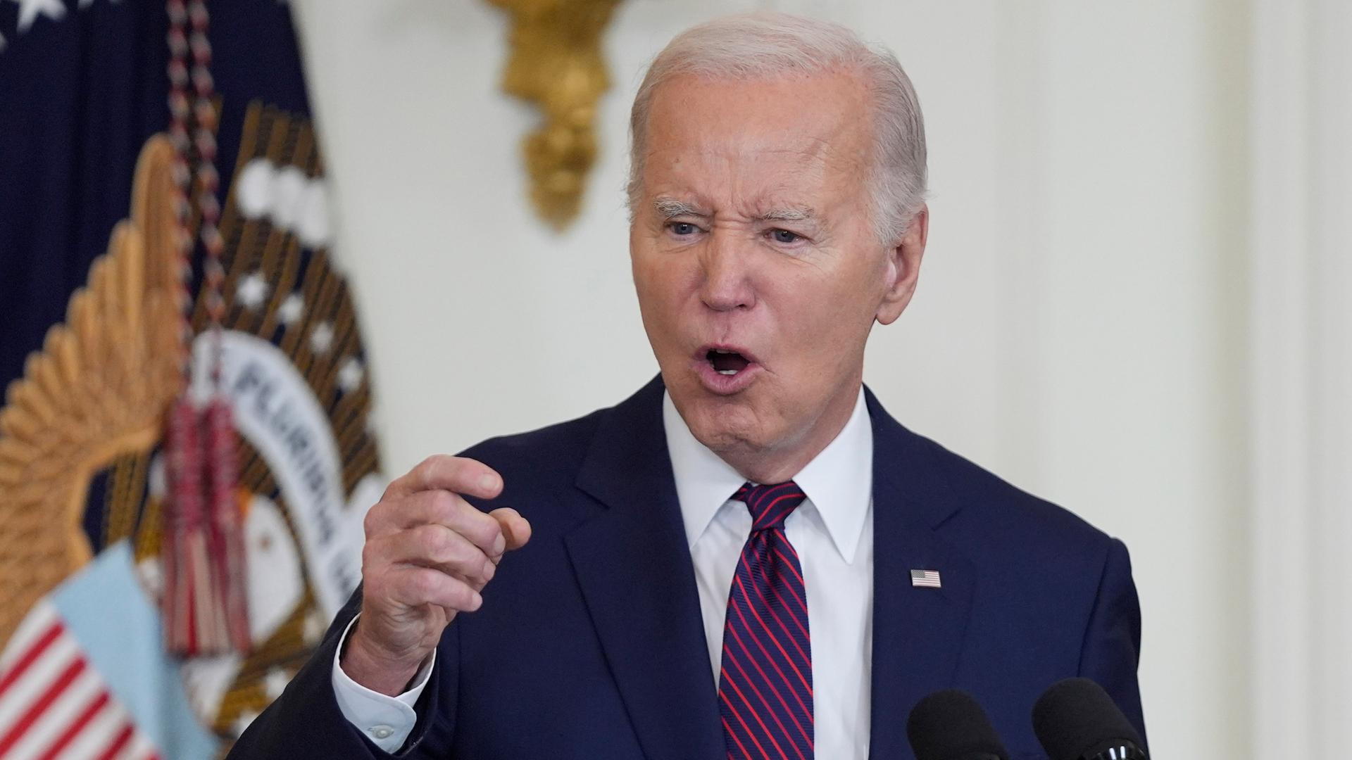 US-Präsident Joe Biden steht vor einem Mikrofon und gestikuliert.
