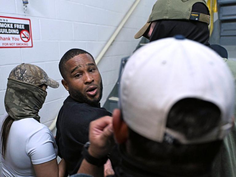 Der letzte Blick eines Häftlings zurück, bevor sich die Tür hinter ihm schließt, während er von ICE-Beamten in Lower Manhatten abgeführt wird. Der letzte Blick eines Häftlings zurück, bevor sich die Tür hinter ihm schließt, während er von ICE-Beamten in Lower Manhatten abgeführt wird.