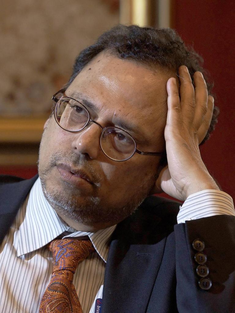 Der bengalische Philosoph Dipesh Chakrabarty bei einem Interview. Er hält den Kopf leicht geneigt und schaut nachdenklich. Seine linke Hand stützt seinen Kopf.