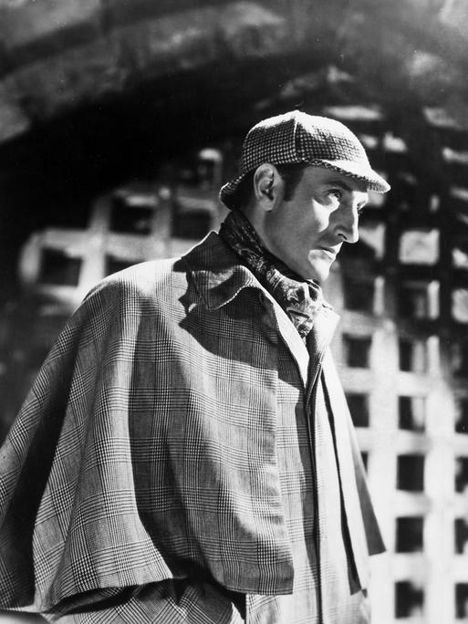 Schwarzweißfoto des Schauspielers Basil Rathbone in der typischen Montur von Sherlock Holmes