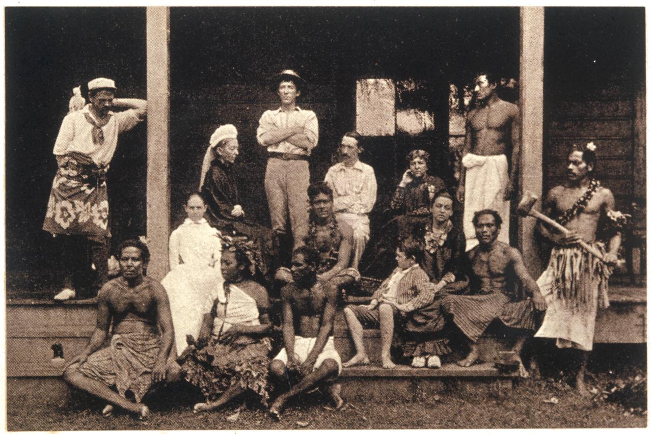 Eine europäisch aussehende Familie zusammen mit samoanischen Ureinwohnern auf einer Veranda.