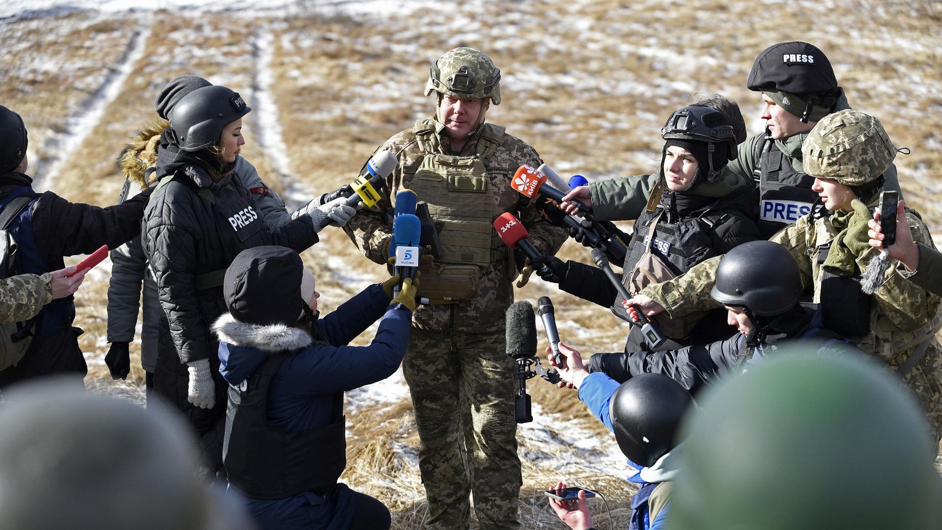 Ein Militär der ukrainischen Armee gibt ein Interview; er ist von Reporterinnen und Reportern umgehen. Alle stehen auf einem Feld. (20.02.2023) Ein Militär der ukrainischen Armee gibt ein Interview; er ist von Reporterinnen und Reportern umgehen. Alle stehen auf einem Feld. (20.02.2023)