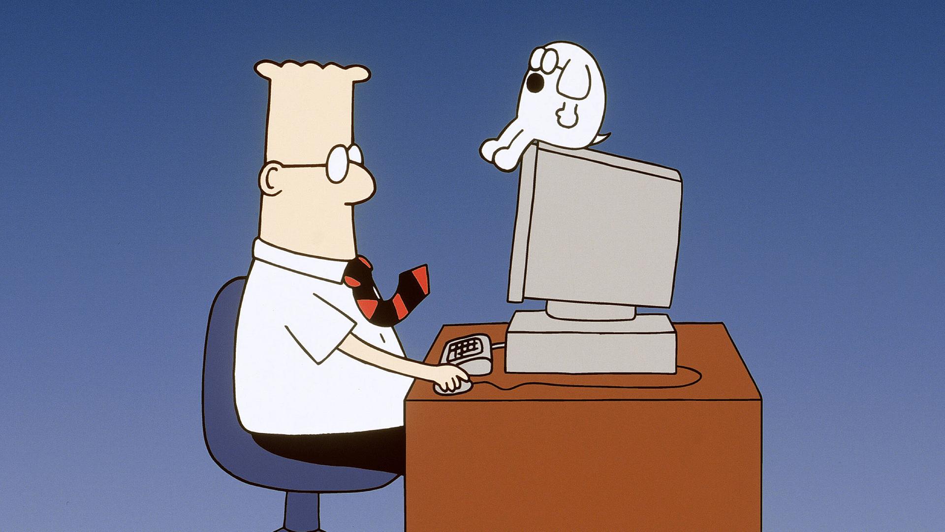 Die Comicfigur Dilbert sitzt an einem Schreibtisch vor einem PC, auf dem sein kleiner Hund Dogbert sitzt.