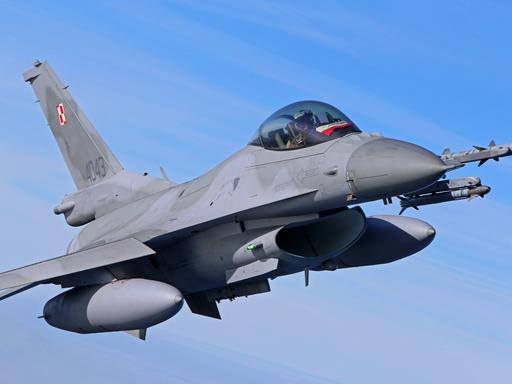 Ein F-16 Kampfjet vor blauem Himmel.