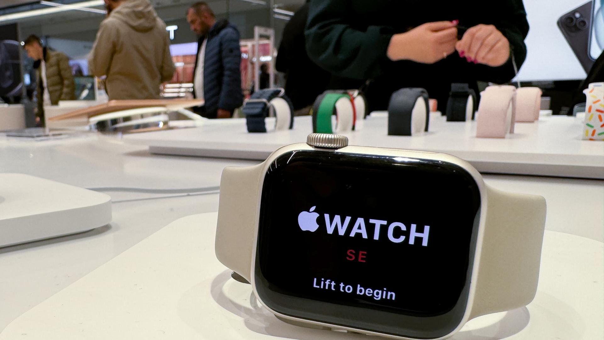 Mehrere Smartwatches der Firma Apple sind in der Auslage eines Geschäftes. 