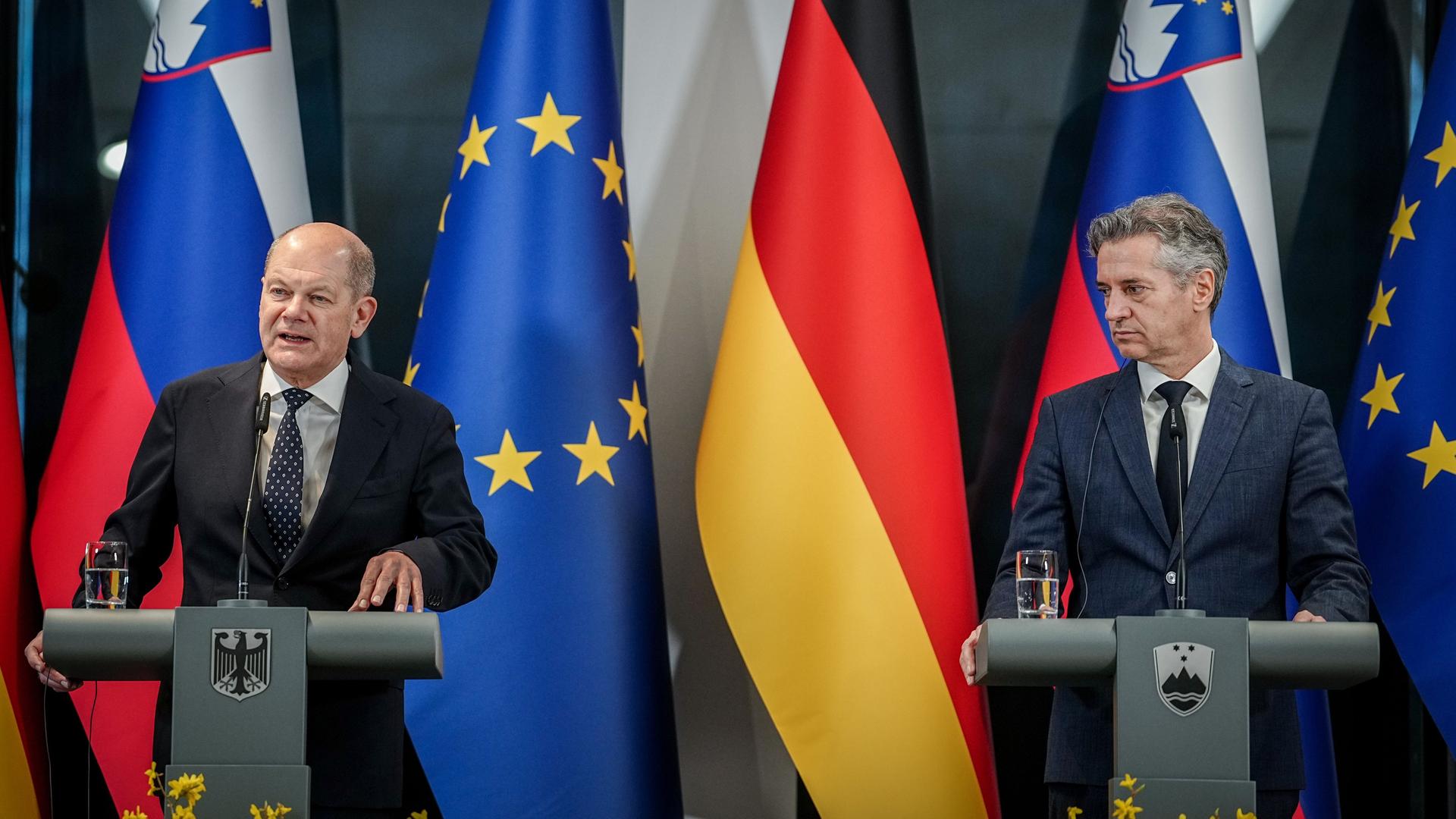 Bundeskanzler Olaf Scholz (links) und Robert Golob, Ministerpräsident der Republik Slowenien, halten eine Pressekonferenz. Im Hintergrund sind die Fahnen der EU, Deutschlands und Sloweniens.