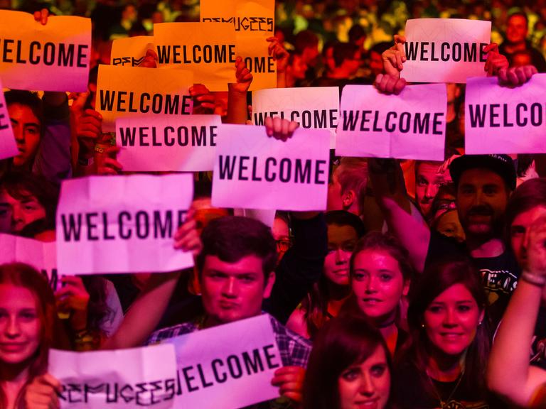 Besucher vom Festival Rock im Sektor mit "Welcome"-Schildern am 05. September 2015.