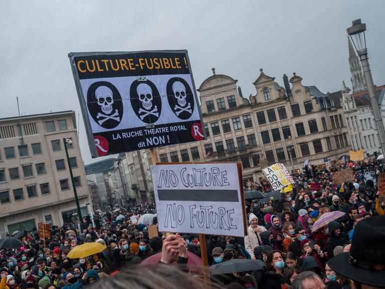 Am 26.12.2021 demonstrieren an die 5000 Kulturschaffende und Kunstfreunde in Brüssel gegen einen Lockdown belgischer Kultureinrichtungen. Etliche halten Transparente mit Parolen hoch.