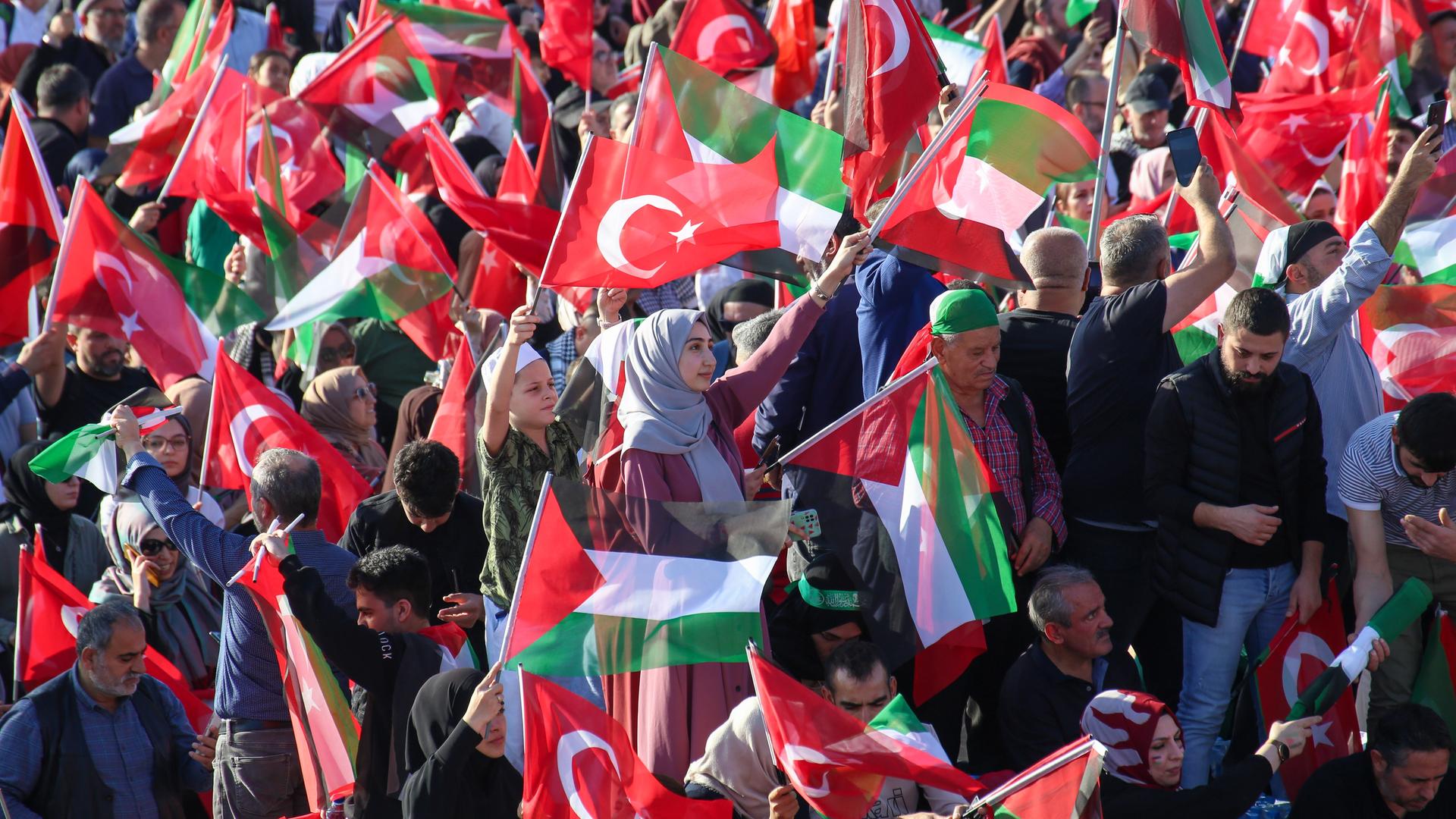Eine Menschenmenge mit türkischen und palästinensischen Fahnen.