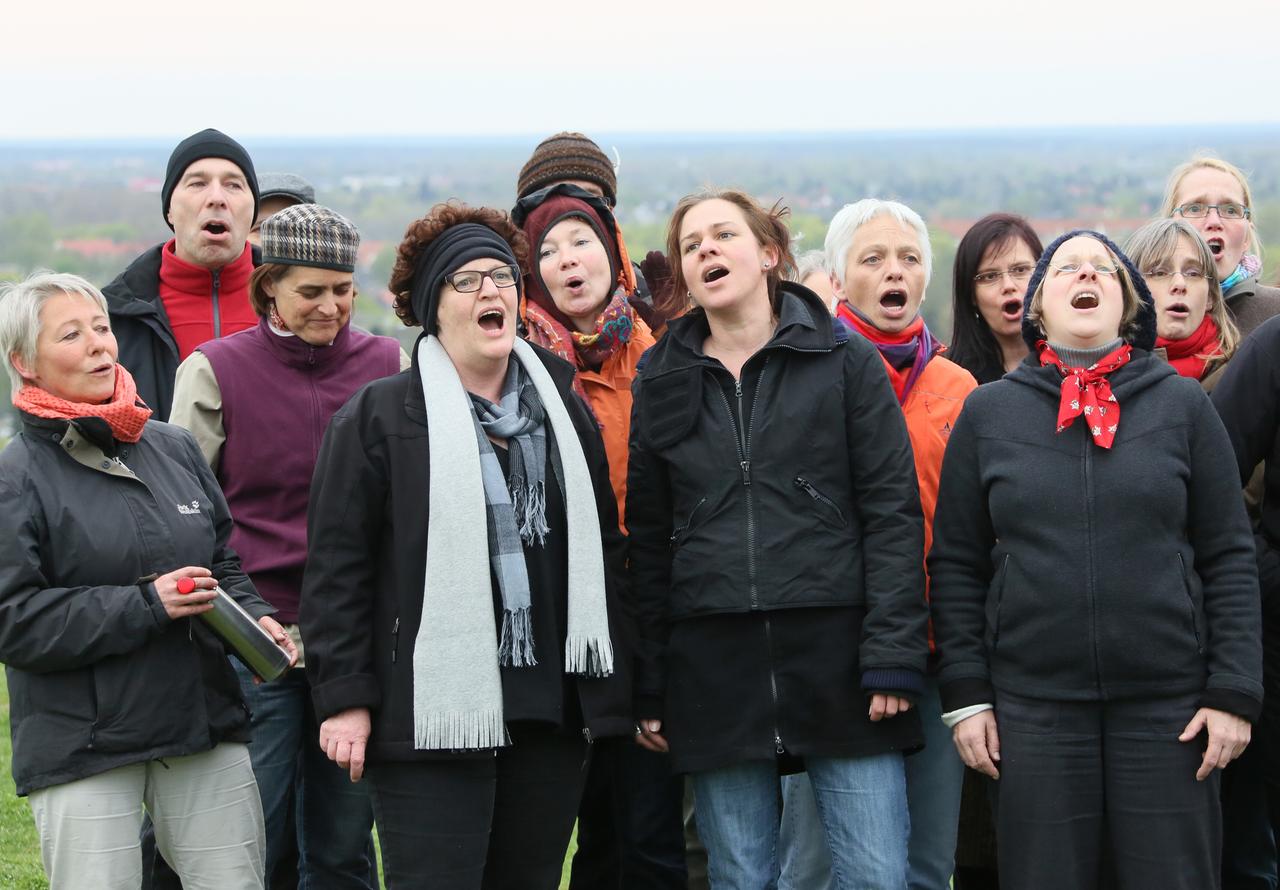 Männer und Frauen stehen im Freien und jodeln