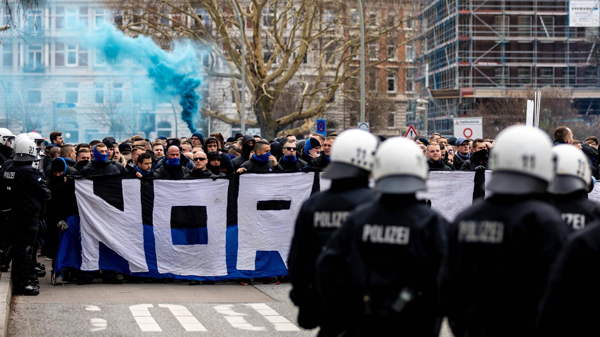 Fans des Hamburger SV marschieren unter Aufsicht der Polizei zum Millerntor-Stadion des FC St. Pauli.