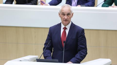 Der designierte russische Verteidigungsminister Beloussow spricht vor dem Parlament. Er steht an einem Pult und spricht in ein Mikrofon. Er trägt einen blauen Anzug, ein weißes Hemd und eine rote Krawatte.
