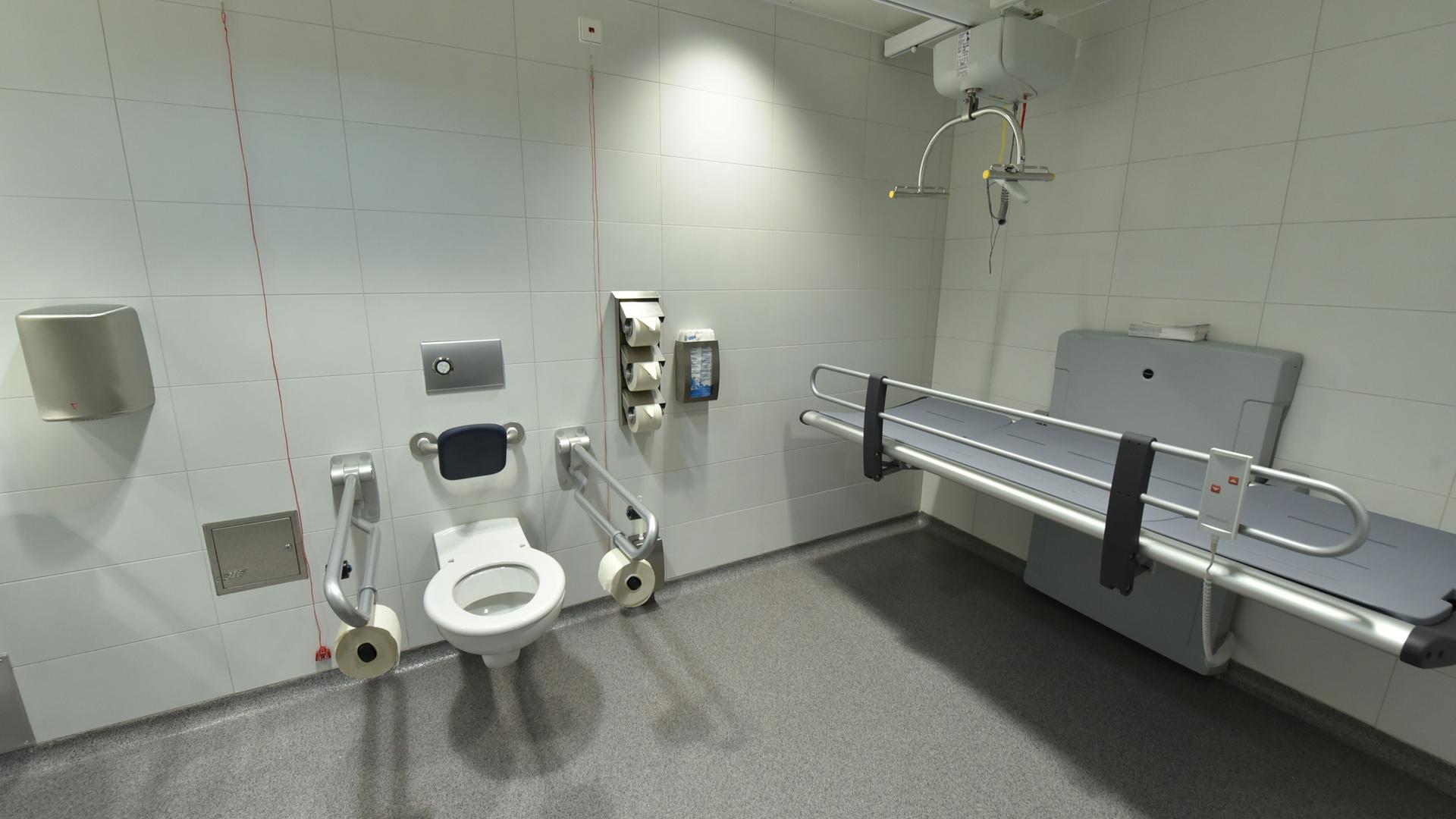 Eine große Behinderten-Toilette mit einer Liegge. Eine große Behinderten-Toilette mit einer Liegge.