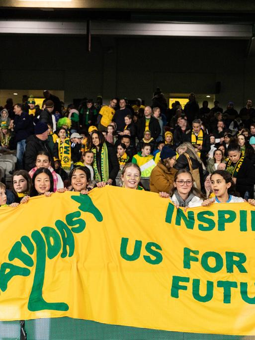 Australische junge Fans mit einem Plakat an die australische Frauen-Nationalmannschaft, die "Matildas".