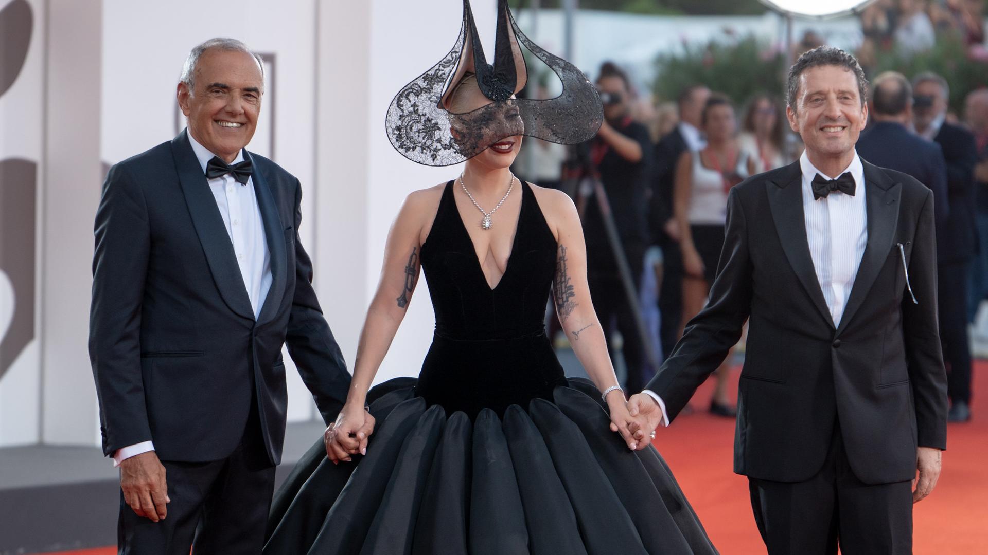 Der umstrittene rechte Festival-Präsident Pietrangelo Buttafuoco (r) mit dem Künstlerischen Leiter Alberto Barbera und Lady Gaga auf dem roten Teppich in Venedig.    