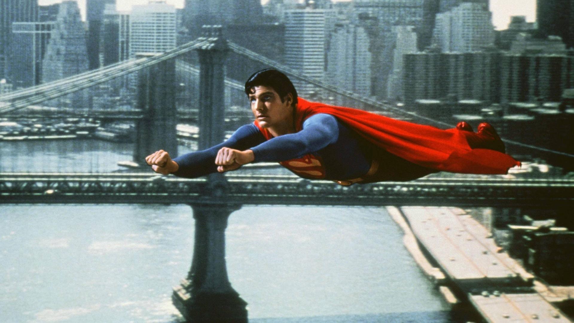 Christopher Reeve im blau-roten Supermankostüm fliegt über New York City in einem Superman-Film von 1980 Christopher Reeve im blau-roten Supermankostüm fliegt über New York City in einem Superman-Film von 1980
